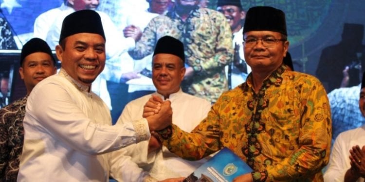 Bupati Labuhanbatu, H Andi Suhaimi Dalimunthe ST MT ketika saat memberikan voucher paket ibadah umroh dari Pemerintah Kabupaten Labuhanbatu.