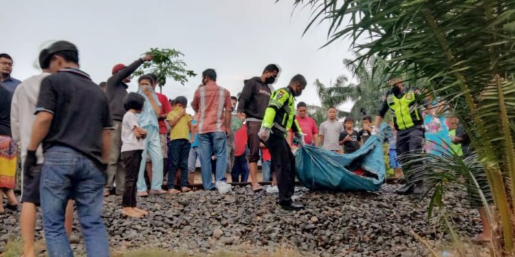 Personel Polsek Kualuh Hulu dan warga mengevakuasi warga yang tertabrak kereta api di perlintasan rel kereta api Kampung Kristen, Kelurahan Aek Kanopan.
foto/teks: richard siallagan