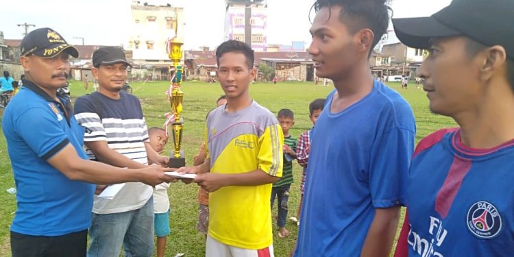 Kepala Desa Rakyat Pekan, Suyadi dan Ketua Pelaksana Pertandingan, Zulvirman Siagian menyerahkan trophy kepada para juara pertandingan LIDUS Cup.
foto/teks: sofyan butar butar