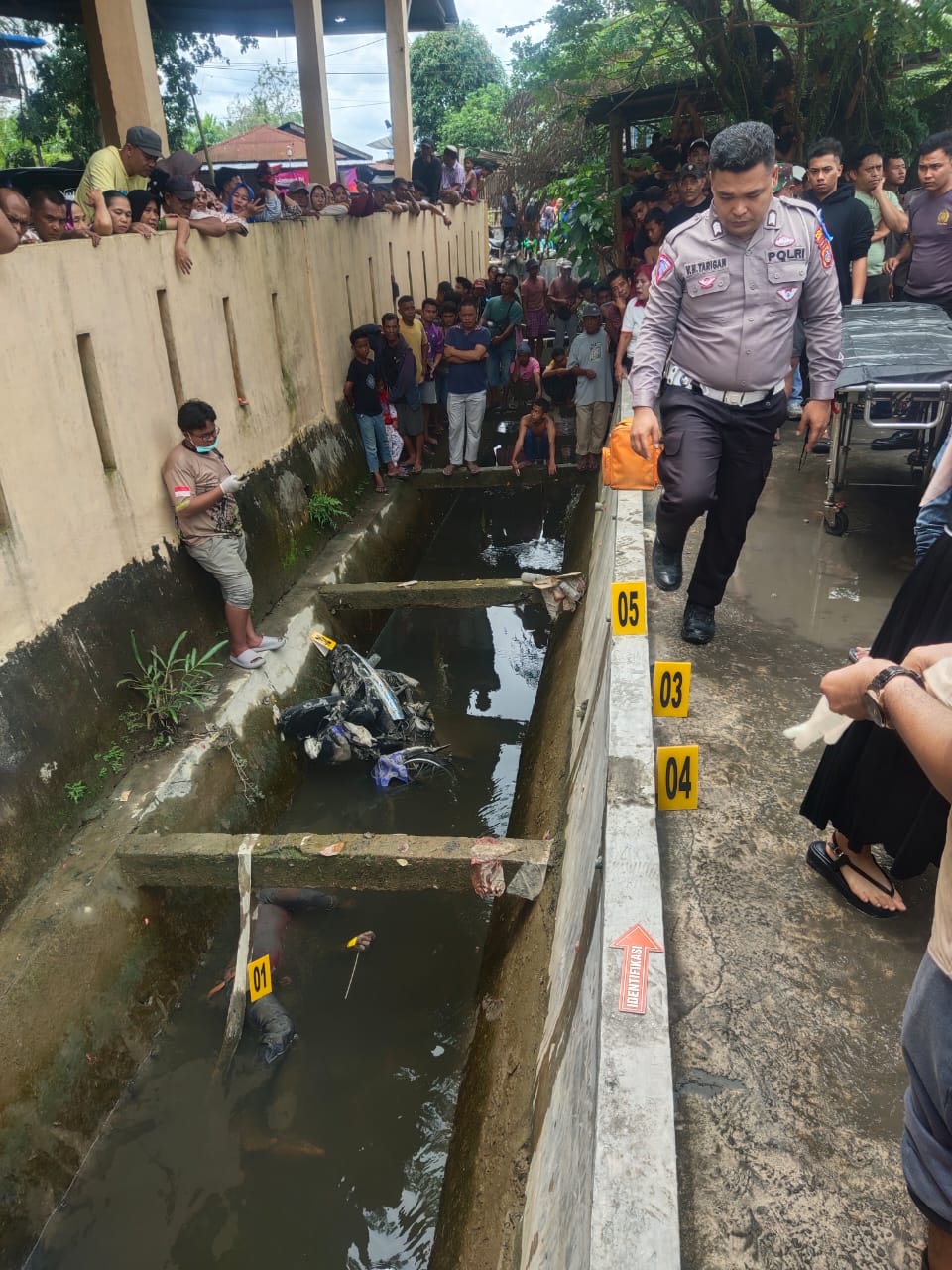 Petugas dibantu warga melakukan evakuasi terhadap jenazah korban.